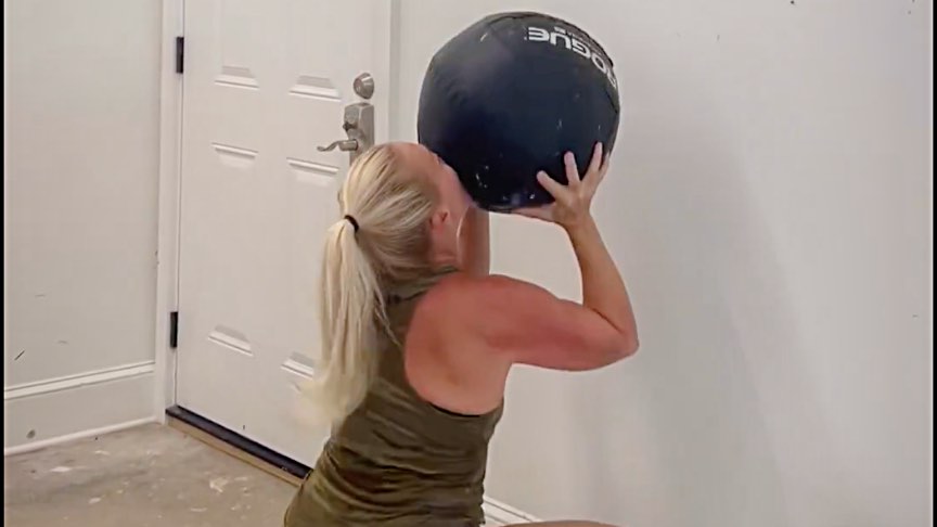Rep. Marjorie Taylor Green works out with a medicine ball.